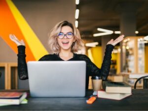 funny-happy-excited-young-pretty-woman-sitting-table-black-shirt-working-laptop-co-working-office-wearing-glasses_285396-86.jpg